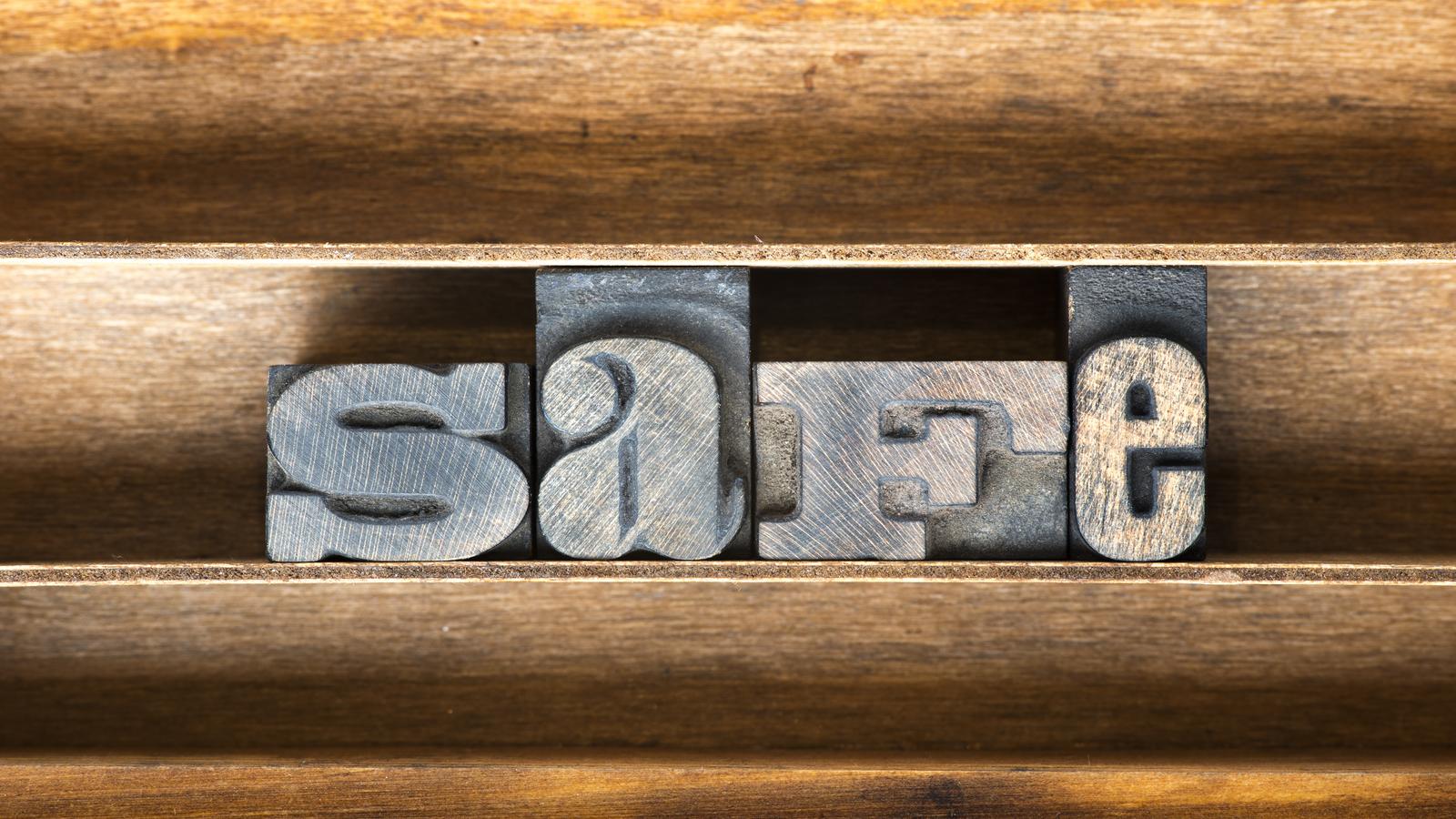 Illustration showing a seed phrase written on paper alongside a metal backup plate and a secure vault
